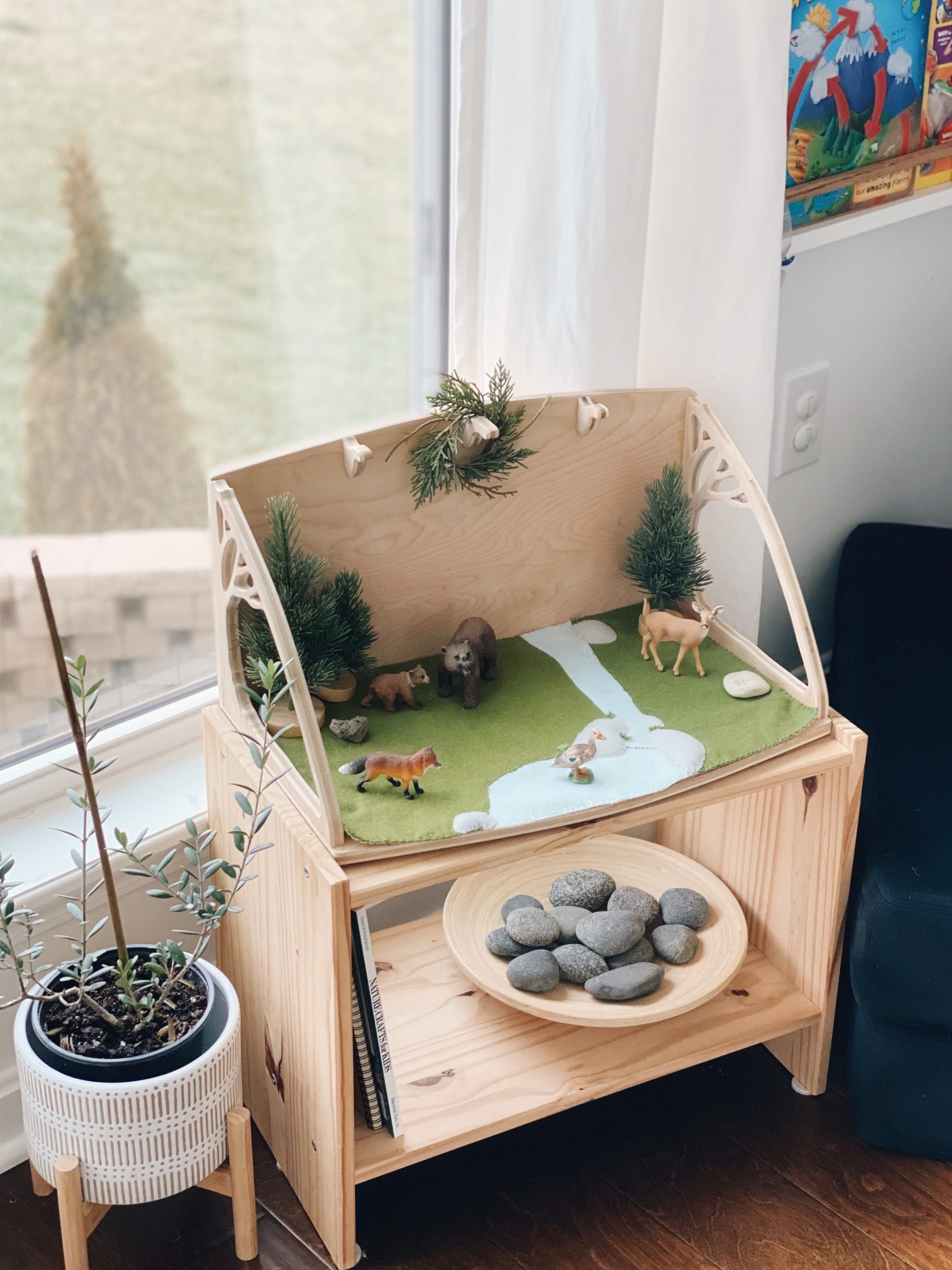 A felt biome play mat sits on an IKEA Rast nightstand. It will be used for storytelling and Montessori grammar presentations. 