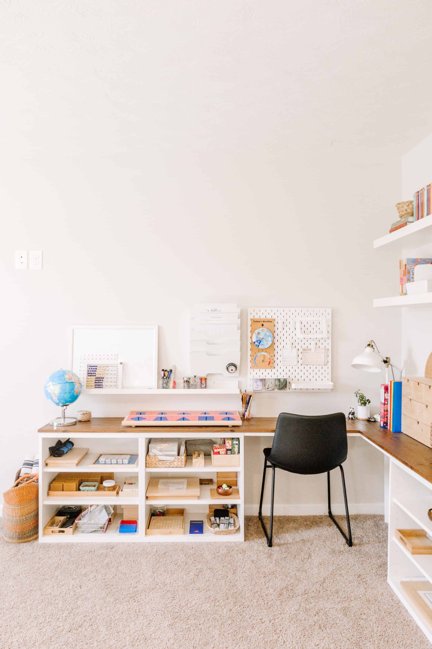 Our Montessori homeschool room includes a custom BESTA corner desk for kids, plus lots of IKEA wall storage accessories to maximize space while keeping materials accessible to our children.  